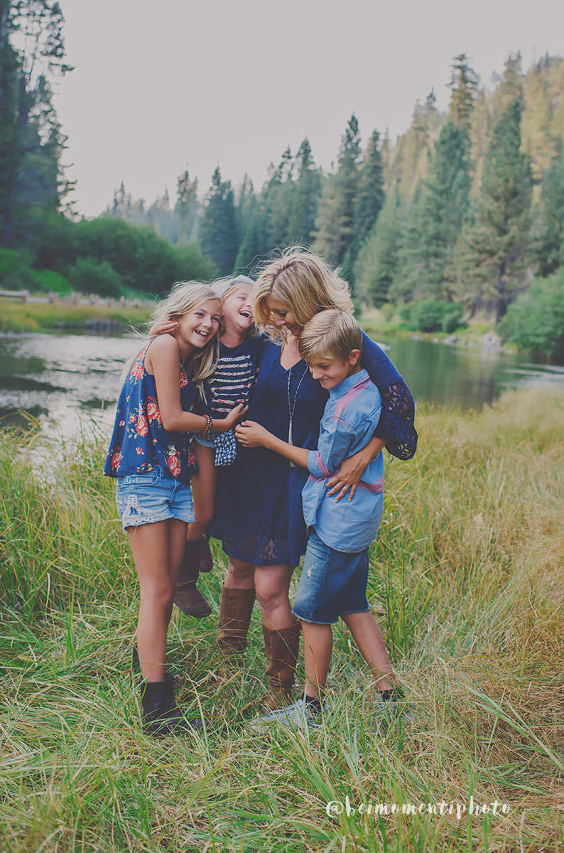 Alicia Cervenka with her children by a lake surrounded by trees