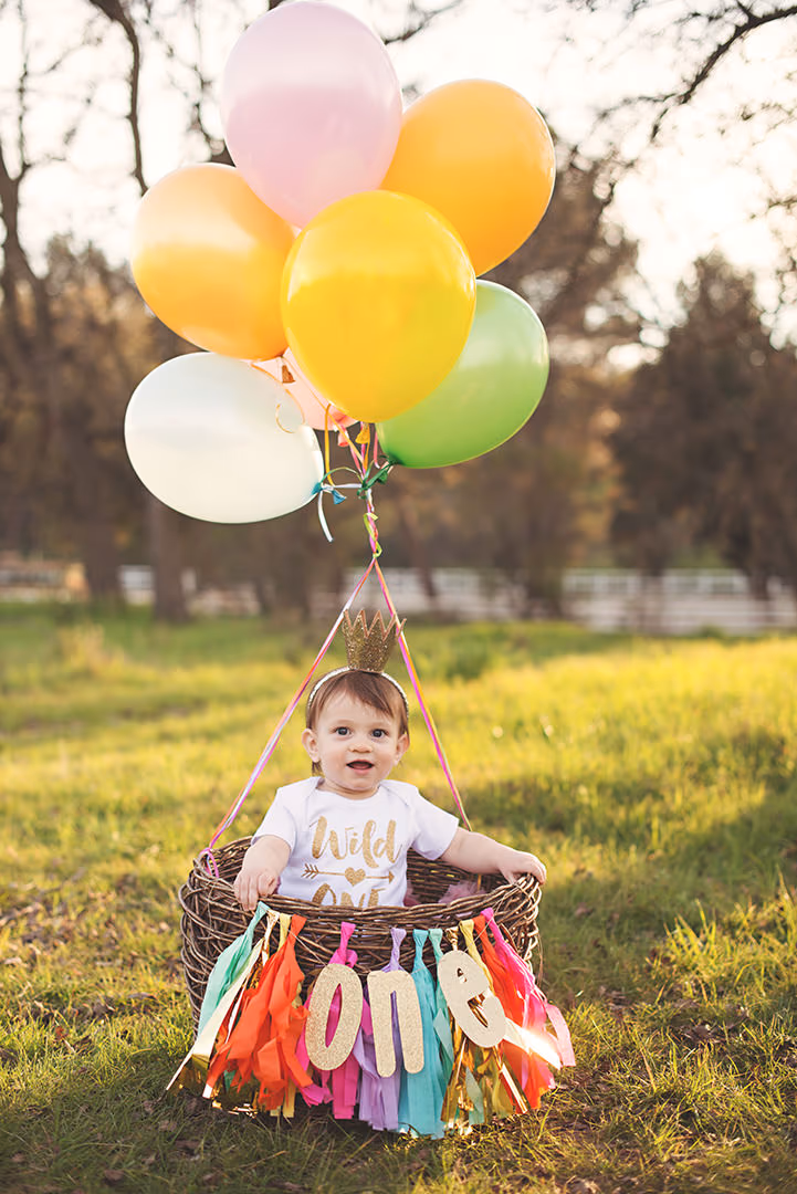 Baby's first birthday milestone portrait session with balloons